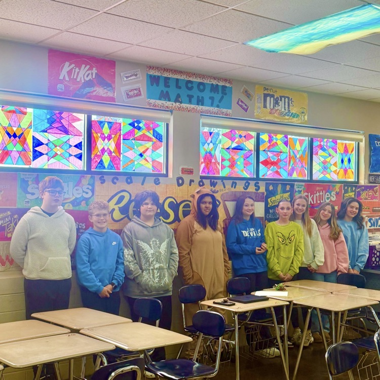 students standing in front of home made stained 