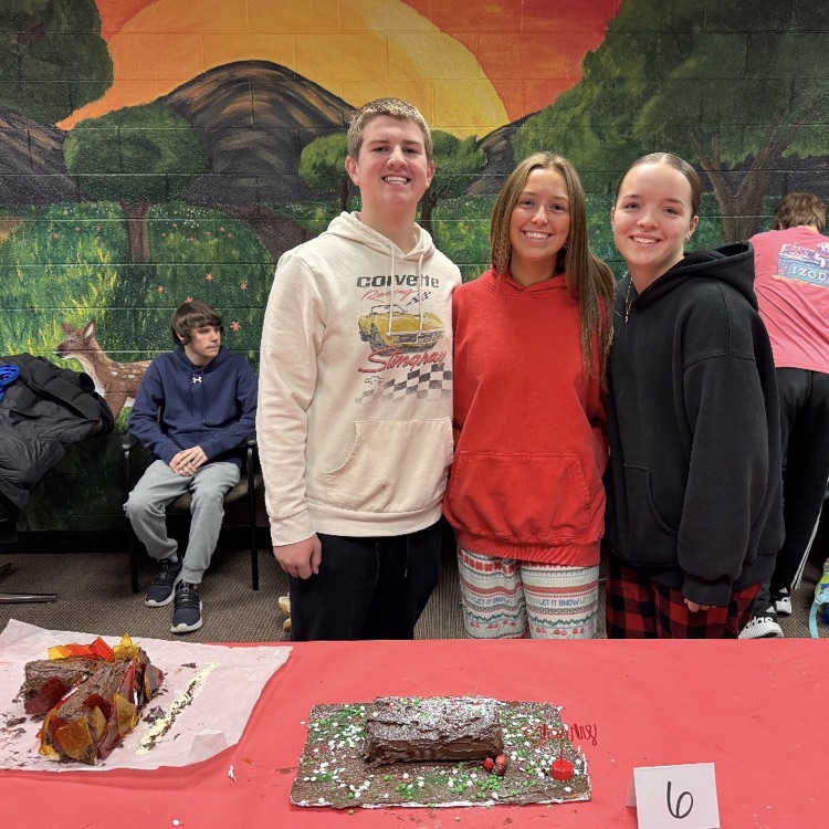 students posing with cakes