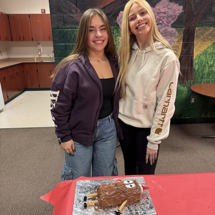 students posing with cakes