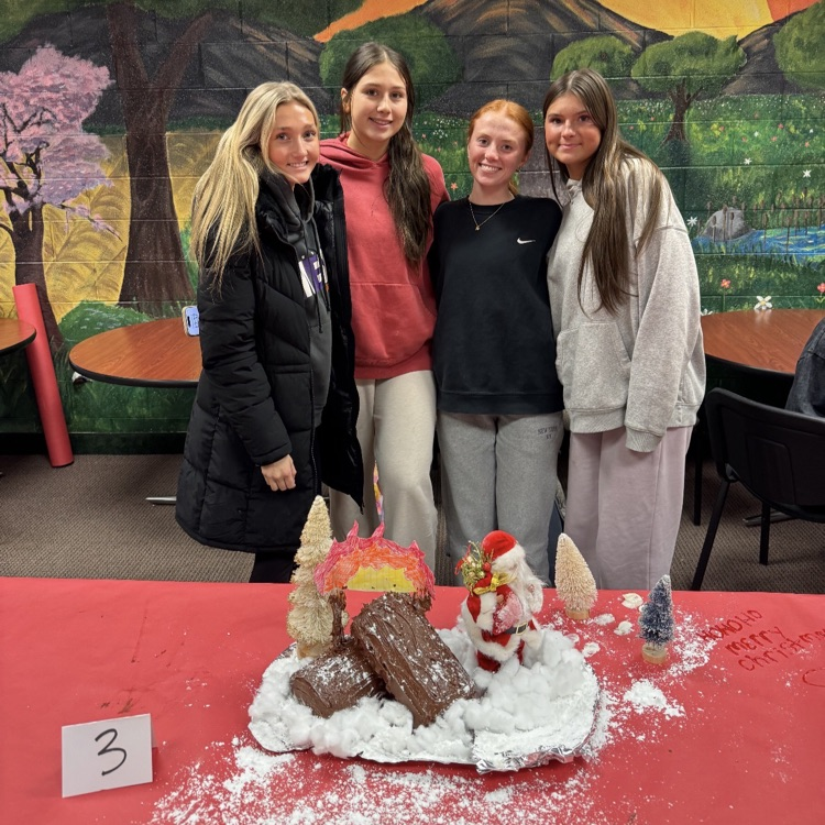 students posing with cakes