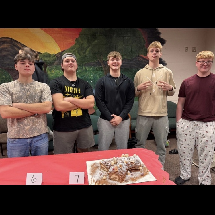 students posing with cakes