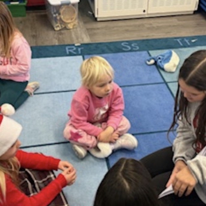 middle school students reading to preschool students