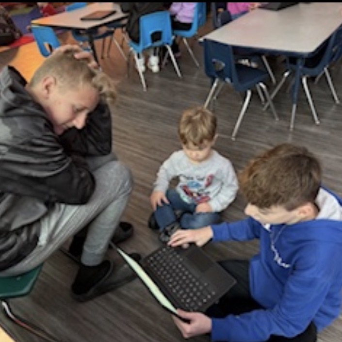 middle school students reading to preschool students