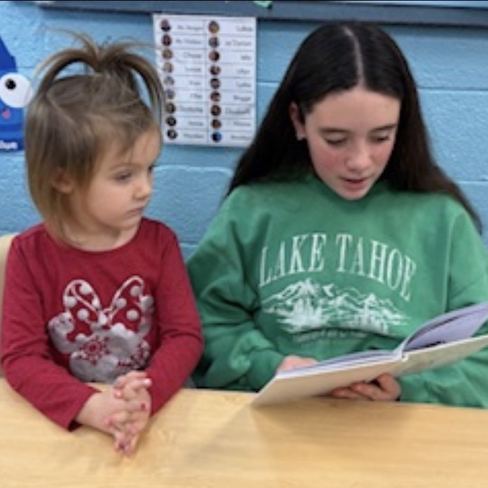 middle school students reading to preschool students