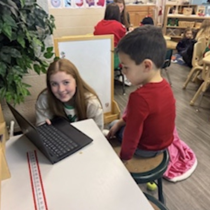 middle school students reading to preschool students