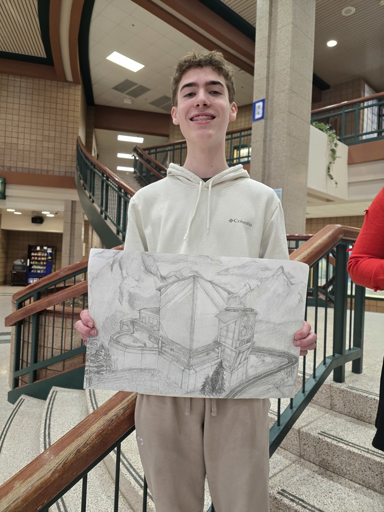 boy holding art work