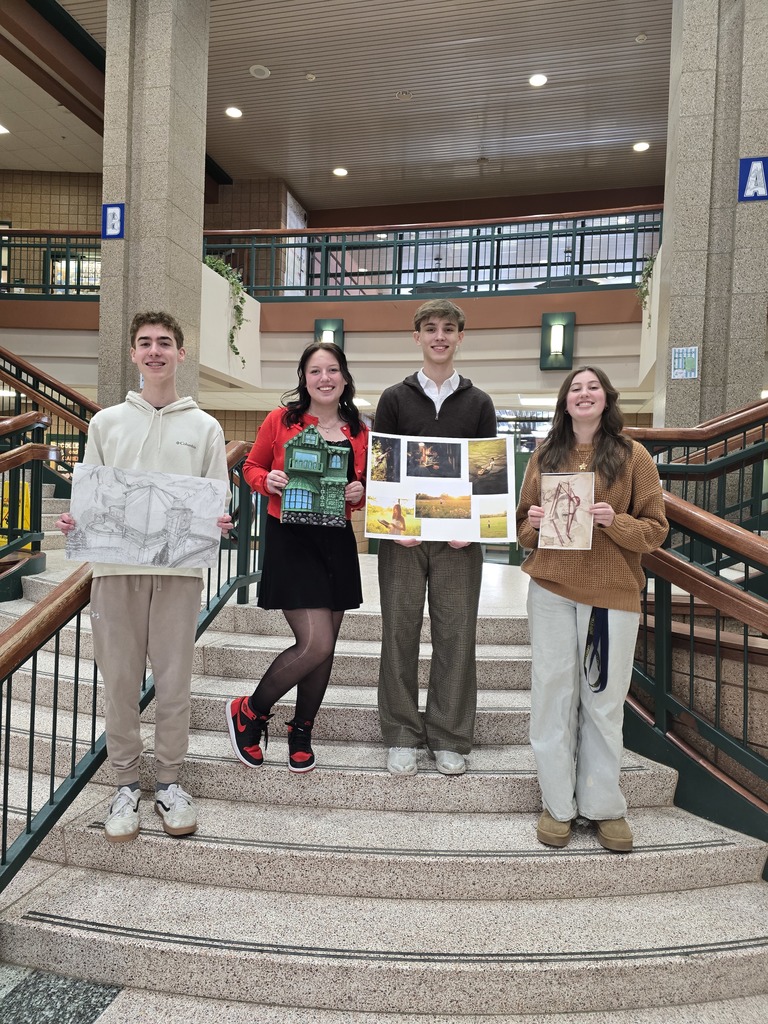 students holding art work