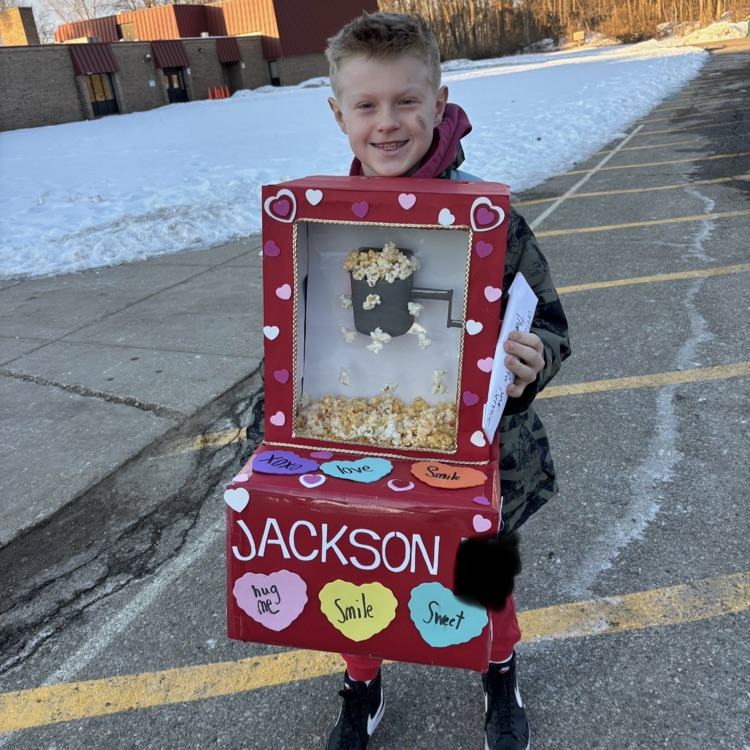 student posing with handmade valentines box