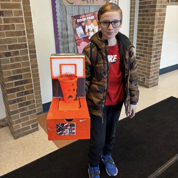 student posing with handmade valentines box