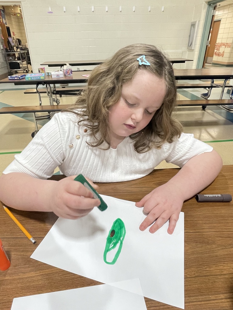 girl drawing with a green marker
