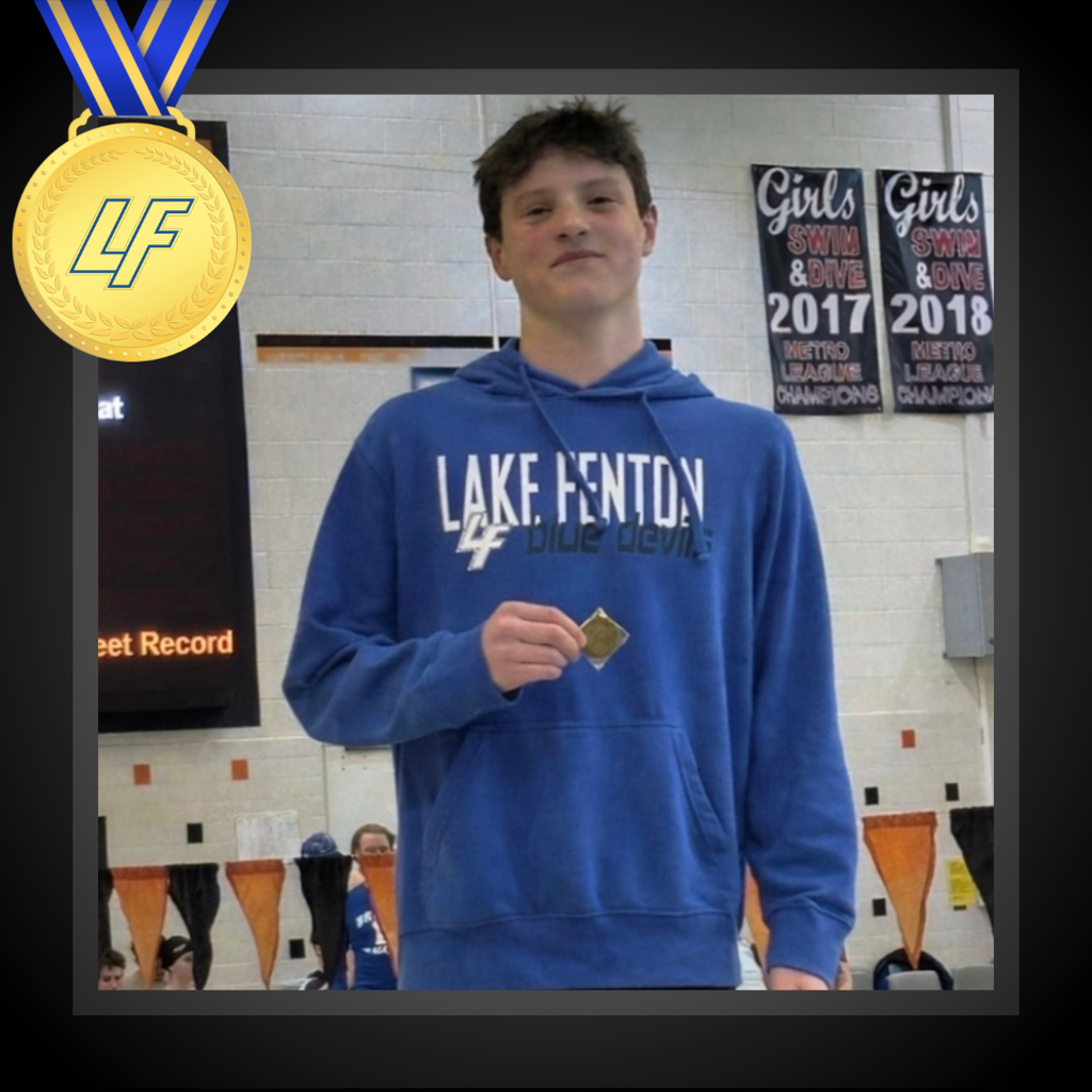 picture of a boy holding a medal