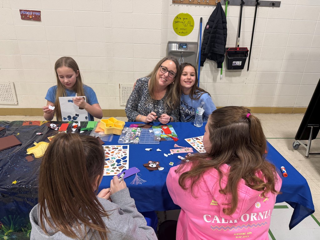 families making a craft and smiling