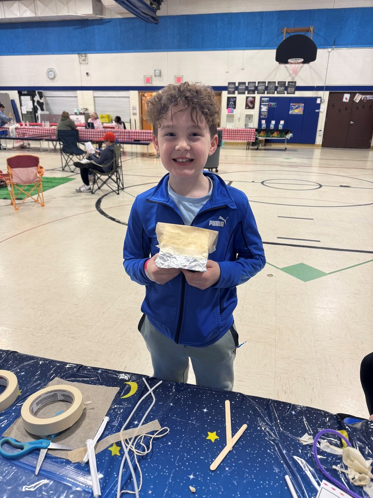 boy holding a handmade craft