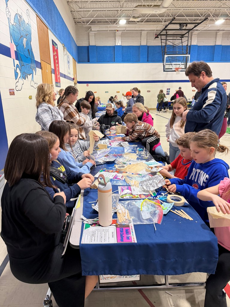 families doing a craft in a gym