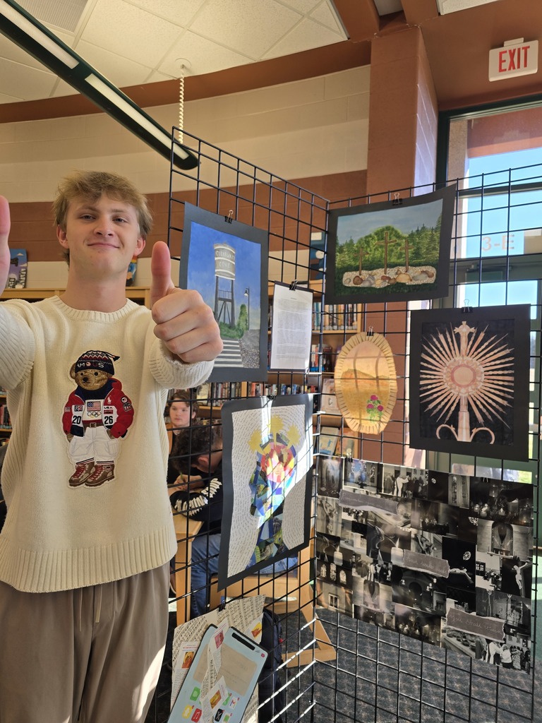 high school student standing in front of art work