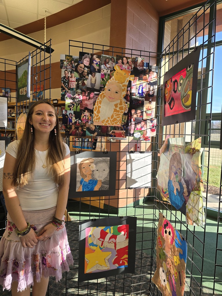 high school student standing in front of art work