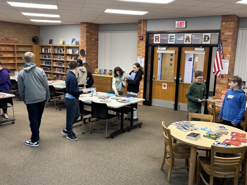 middle school students at a book swap