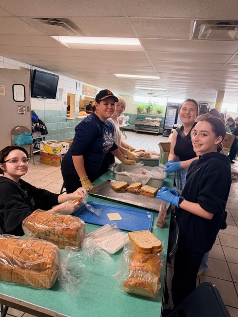 students volunteering at a soup kitchen
