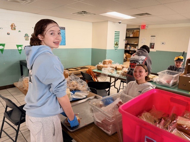 students volunteering at a soup kitchen