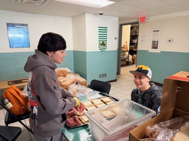 students volunteering at a soup kitchen