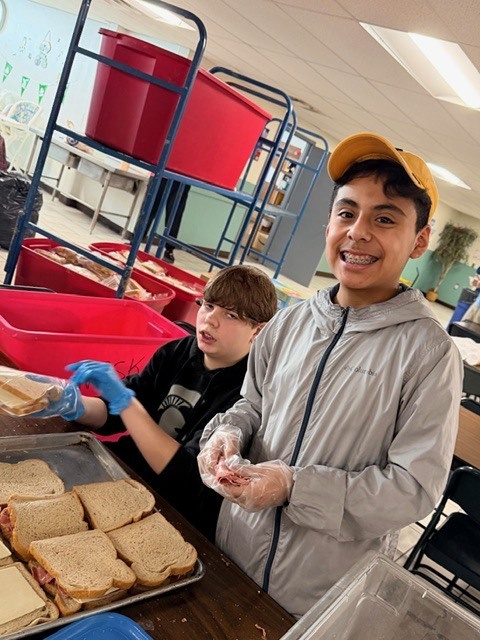students volunteering at a soup kitchen