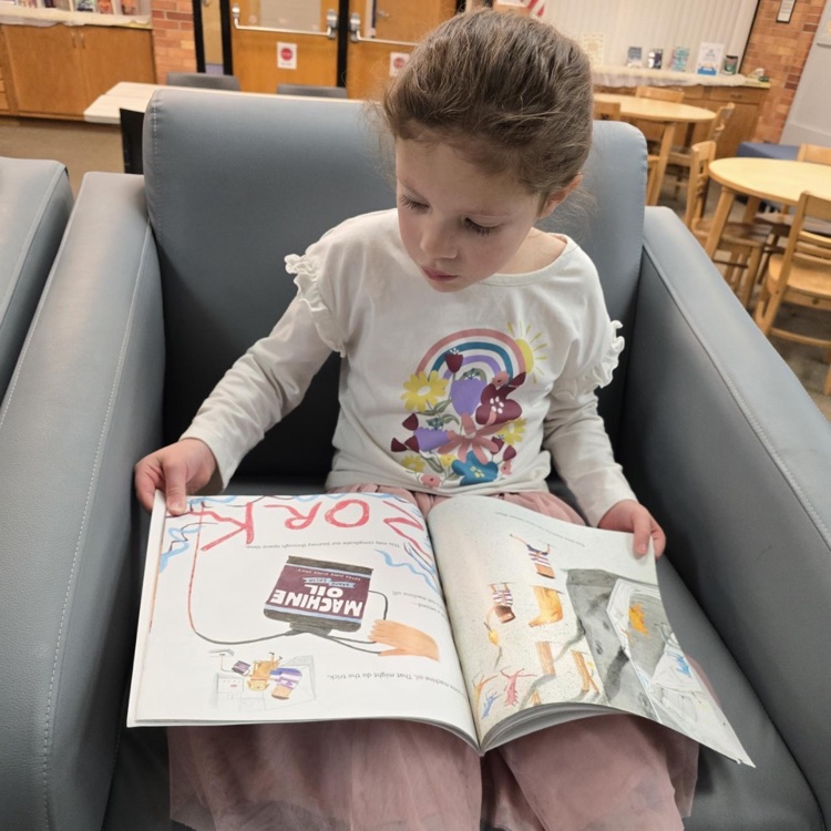 little girl holding a book