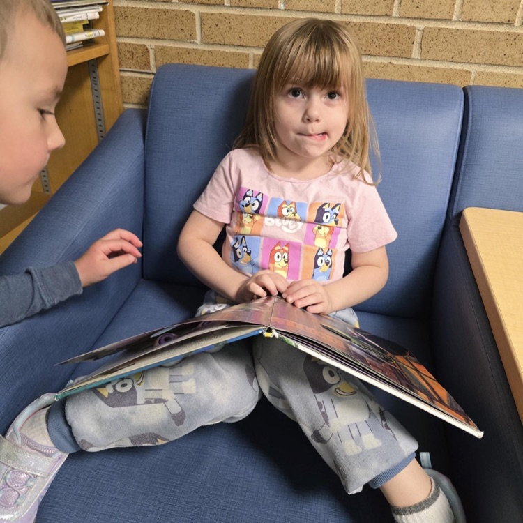 little girl holding a book