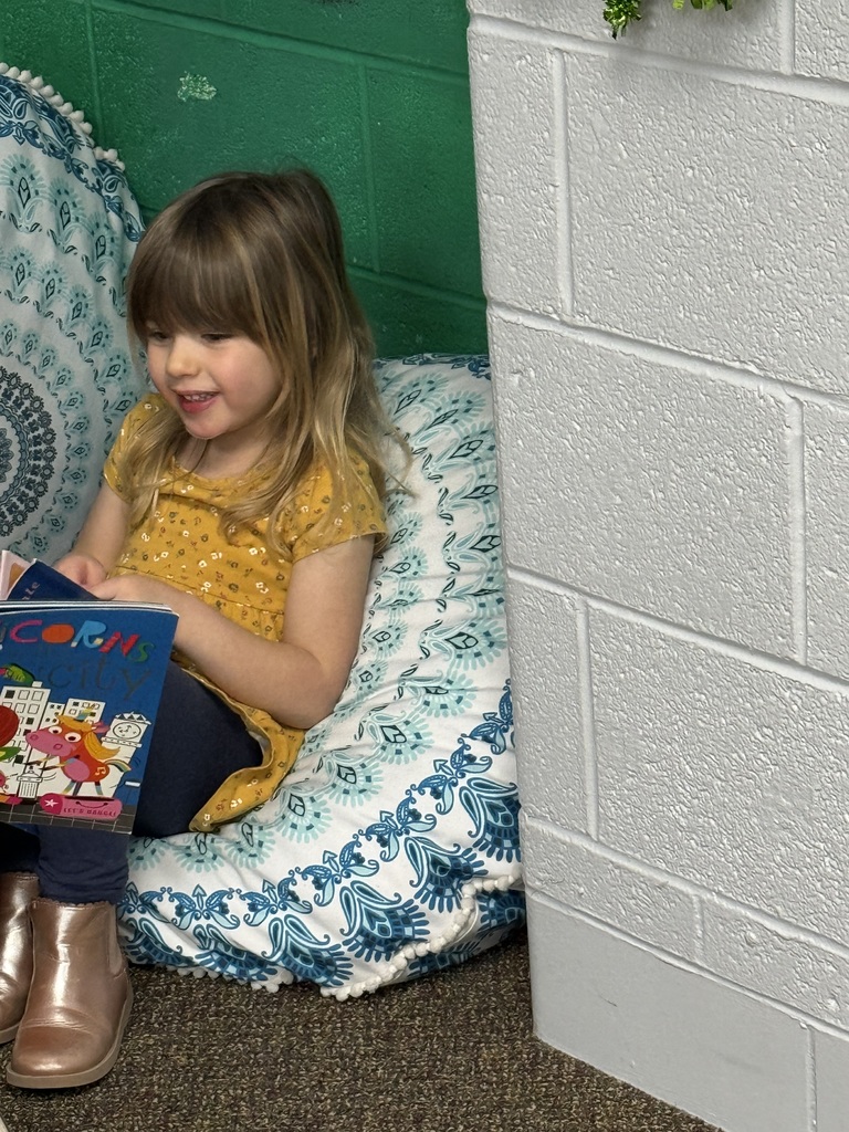 little girl sitting holding a book