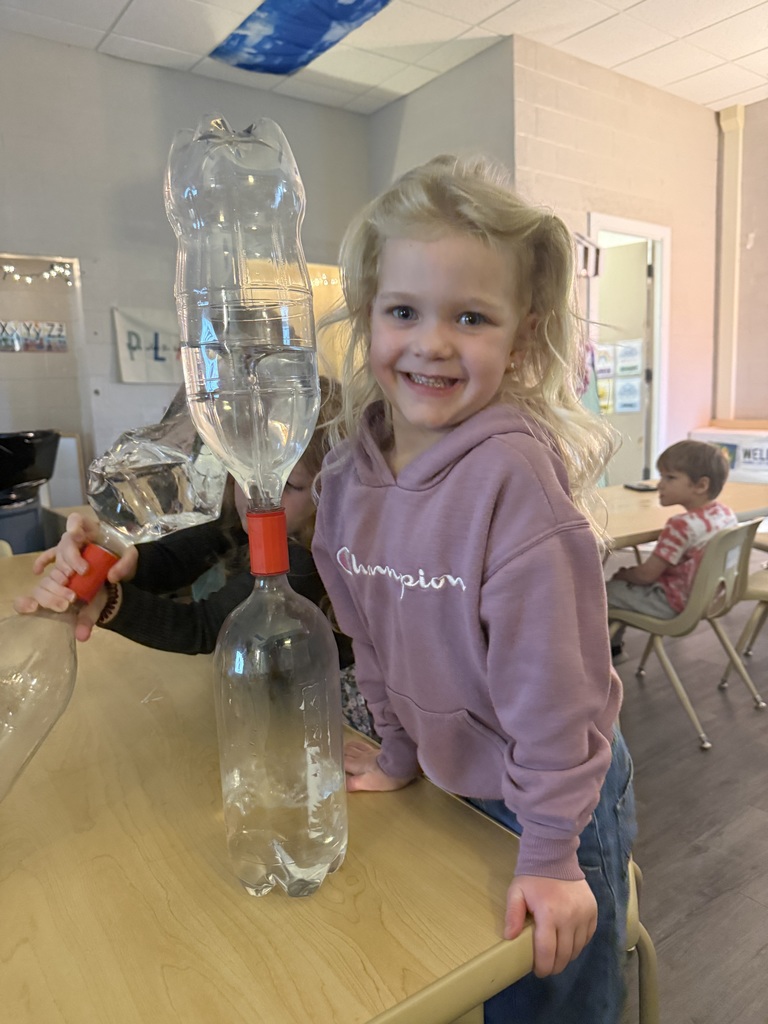 girl posing with clear bottles
