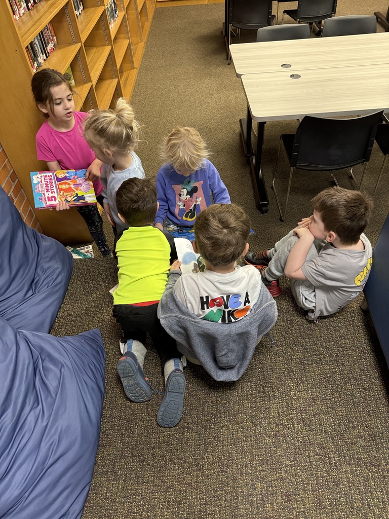group of kids reading in a library