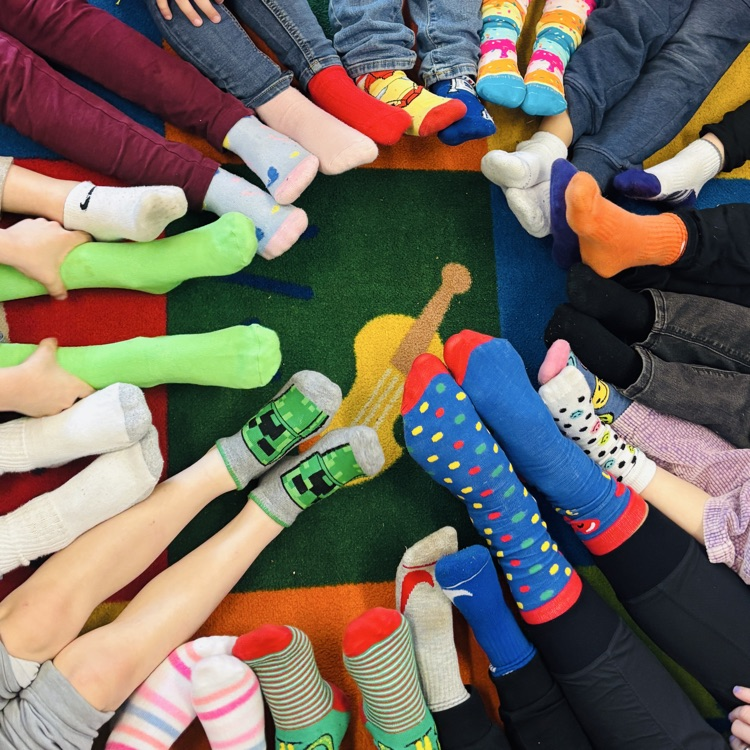 peoples feet with different socks in a circle