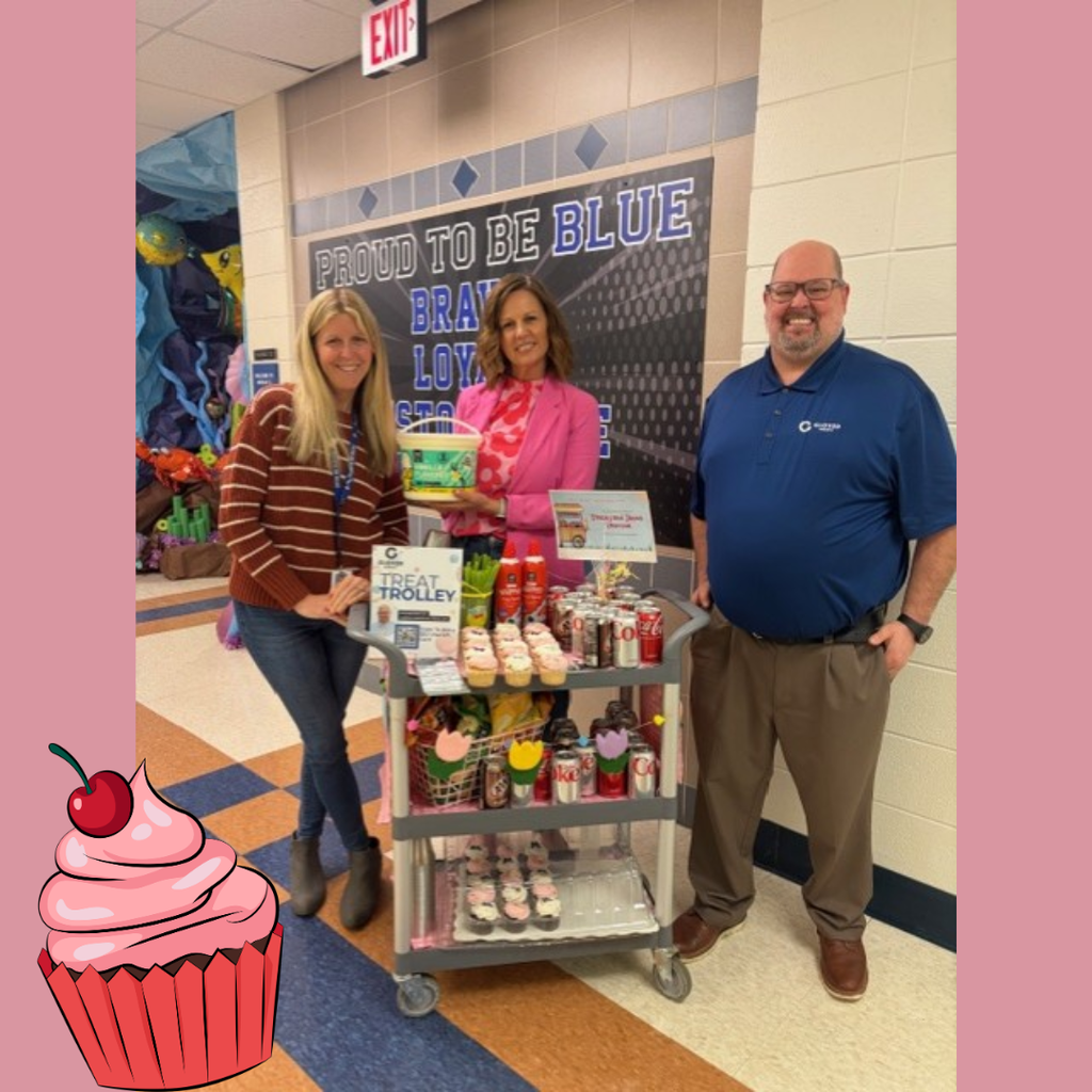 3 adults posing with a cart filled with snacks and drinks