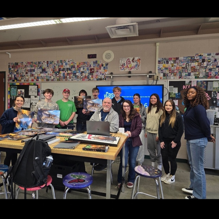 man posing with high school class