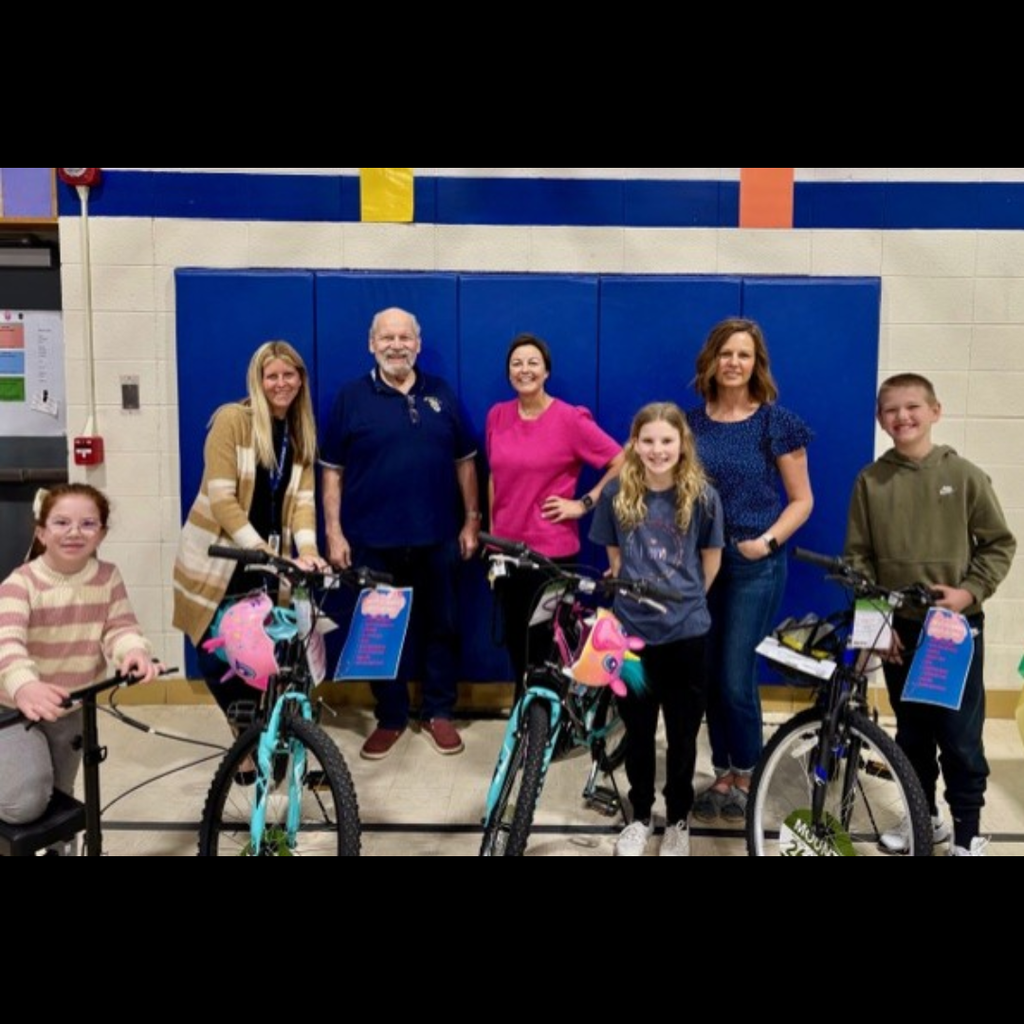 adults adn children posing with bikes