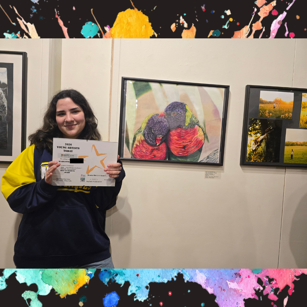 girl holding certificate standing by art