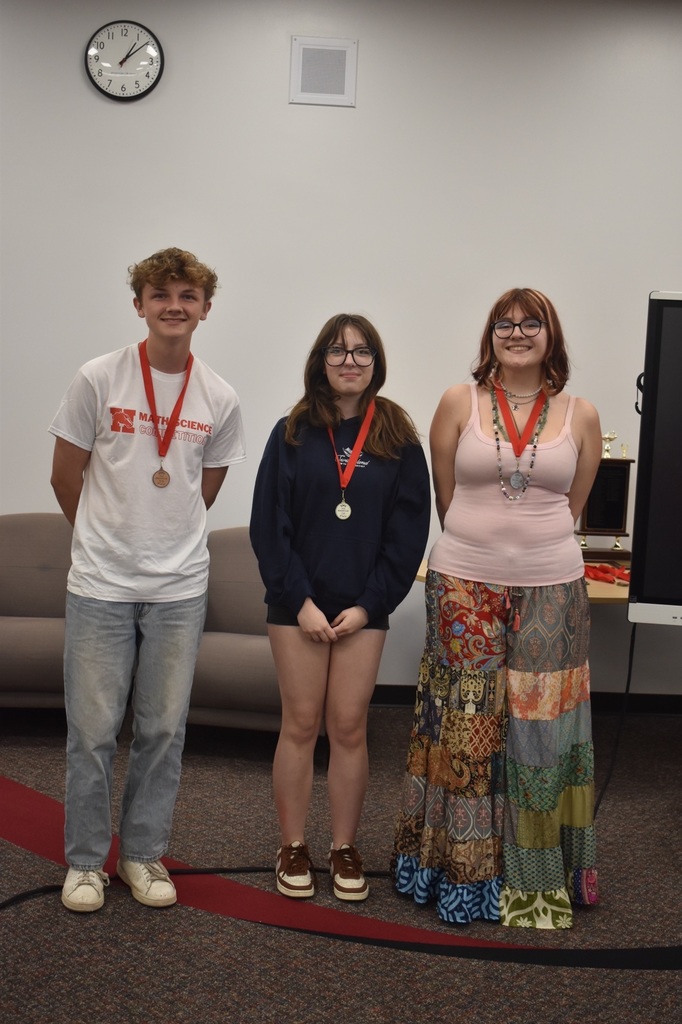 3 students wearing medals