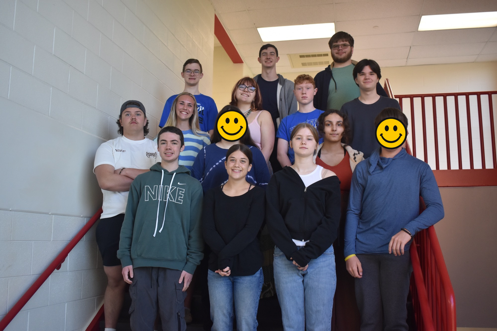 group of students posing on a staircase