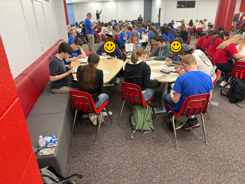 large group of high school students taking a test