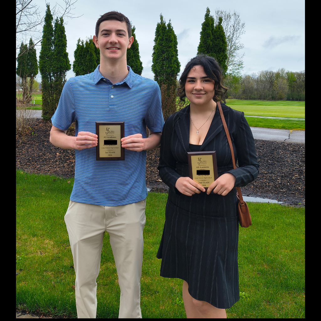 2 high school students posing with awards