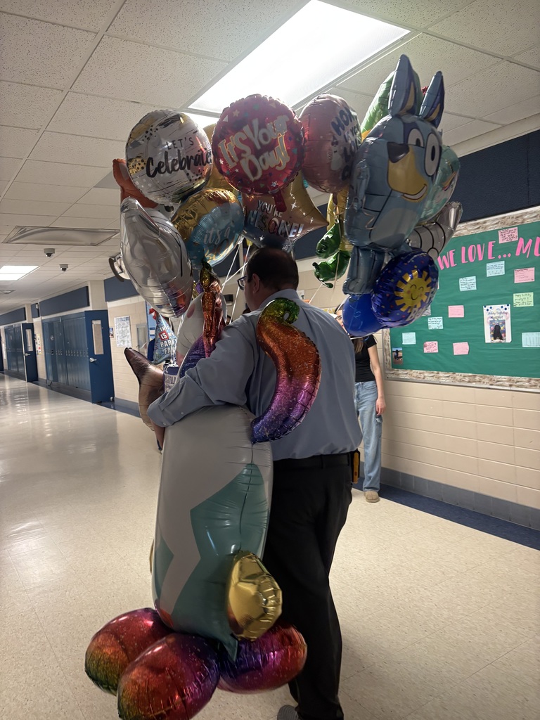 principal holding balloons
