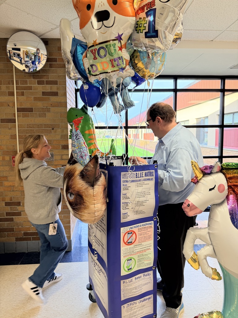 Teacher giving a principal a balloon
