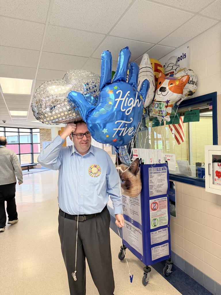 principal holding balloons