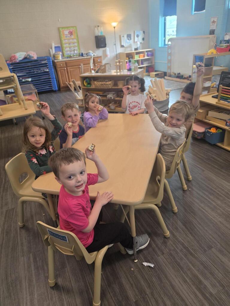 preschool students sitting at a table