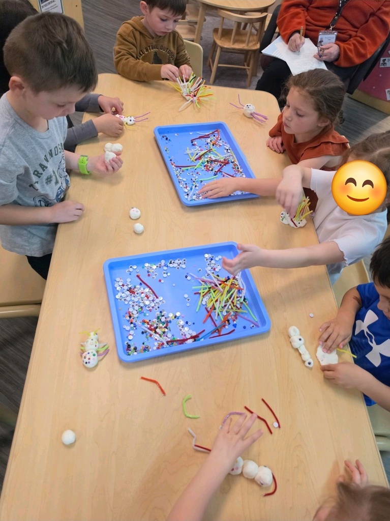 preschool students playing with beads and pipecleaners