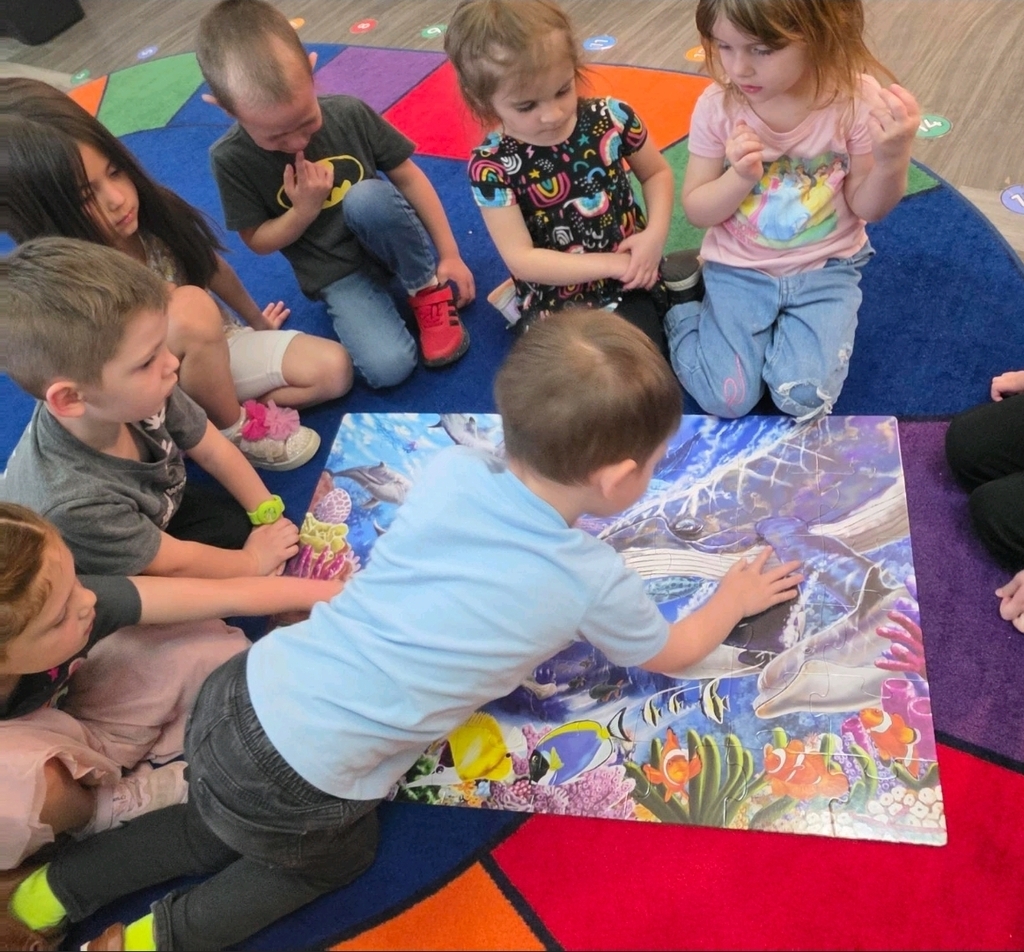 preschool students working on a puzzle