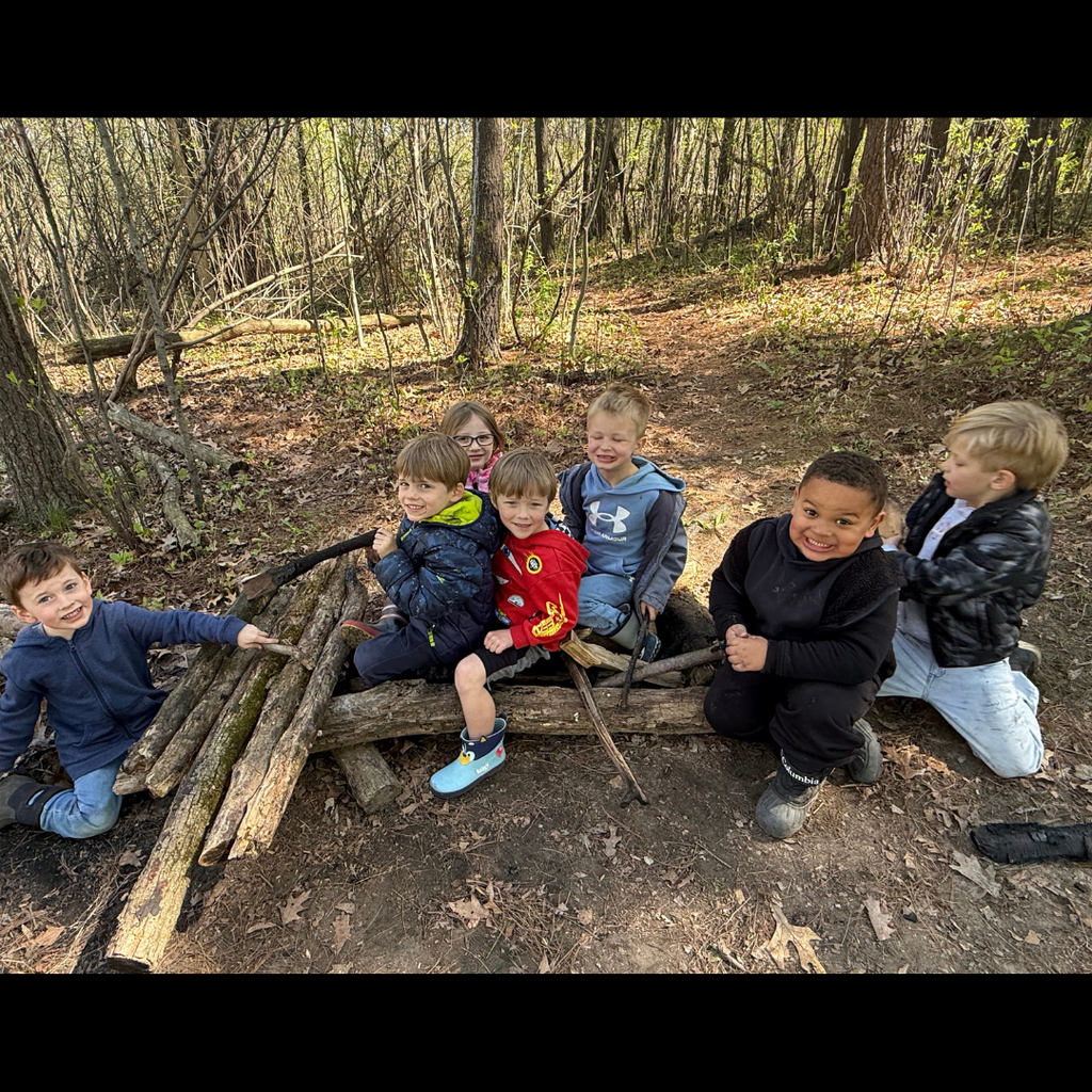 group of kids posing on a log