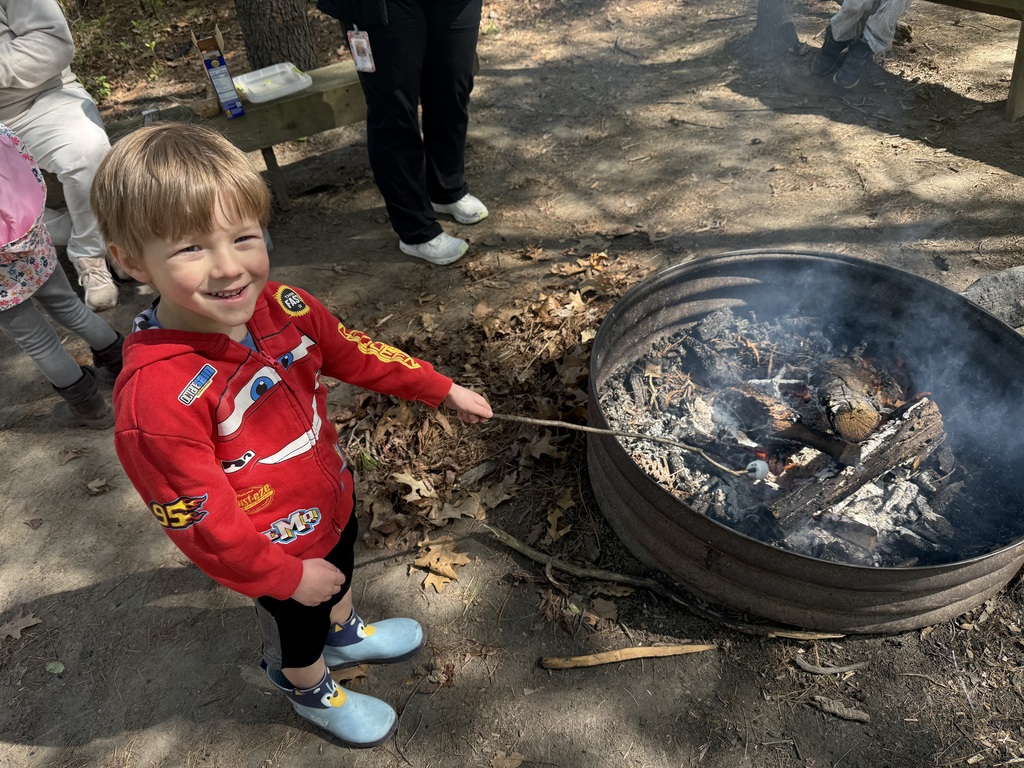 little boy roasting a marshmallow
