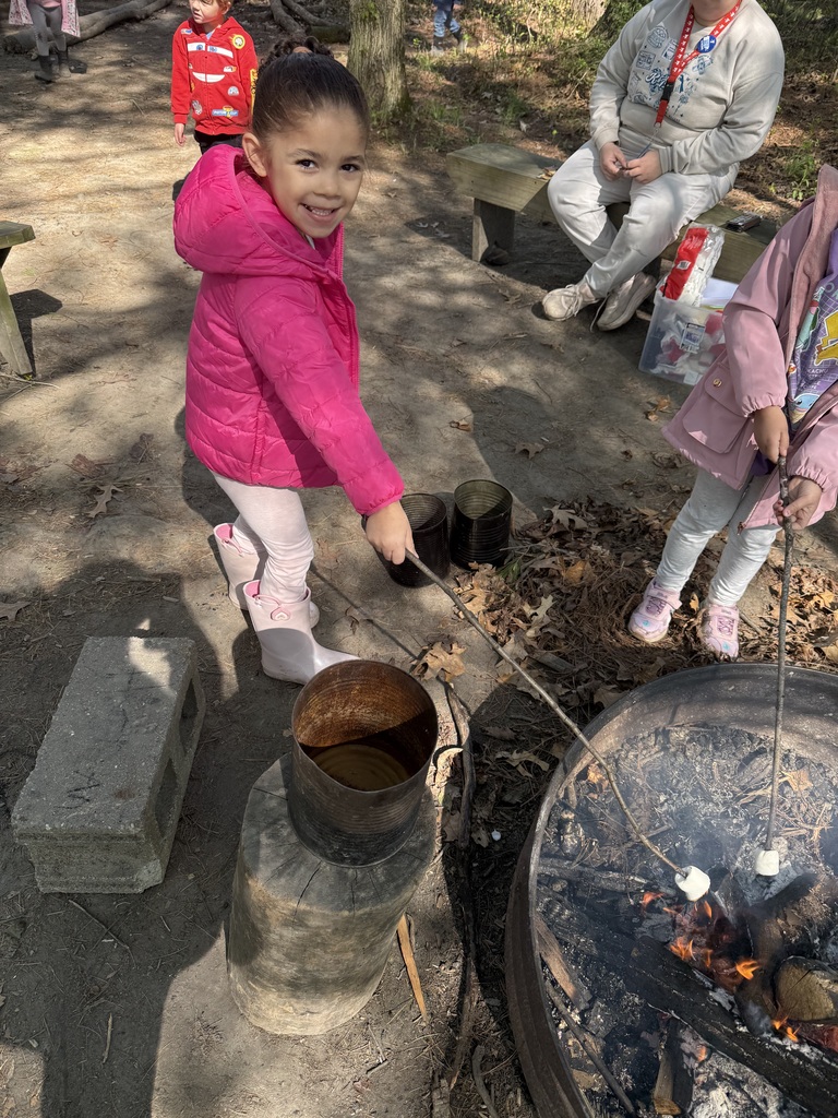 little girl roasting marshmallows