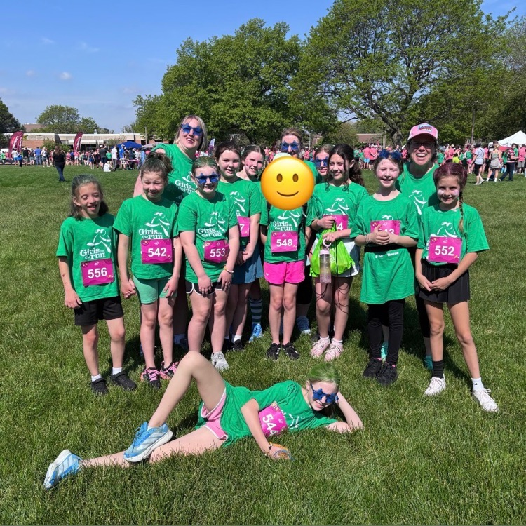 girls posing outside in green shirts