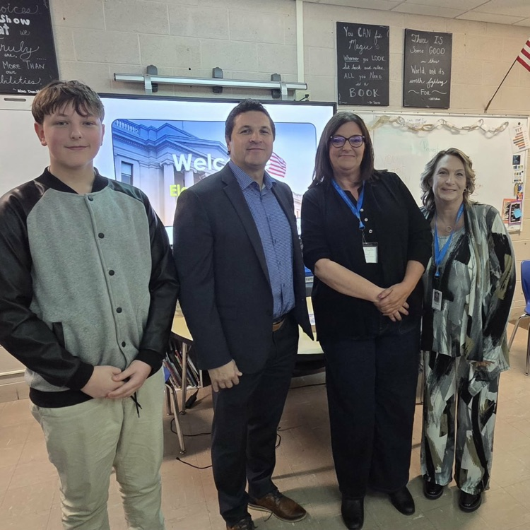 middle school boy posing with 3 adults